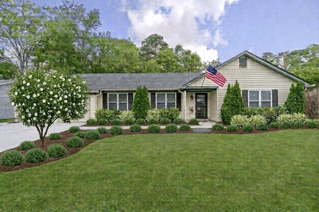 A charming home with a well-maintained lawn and landscaping.